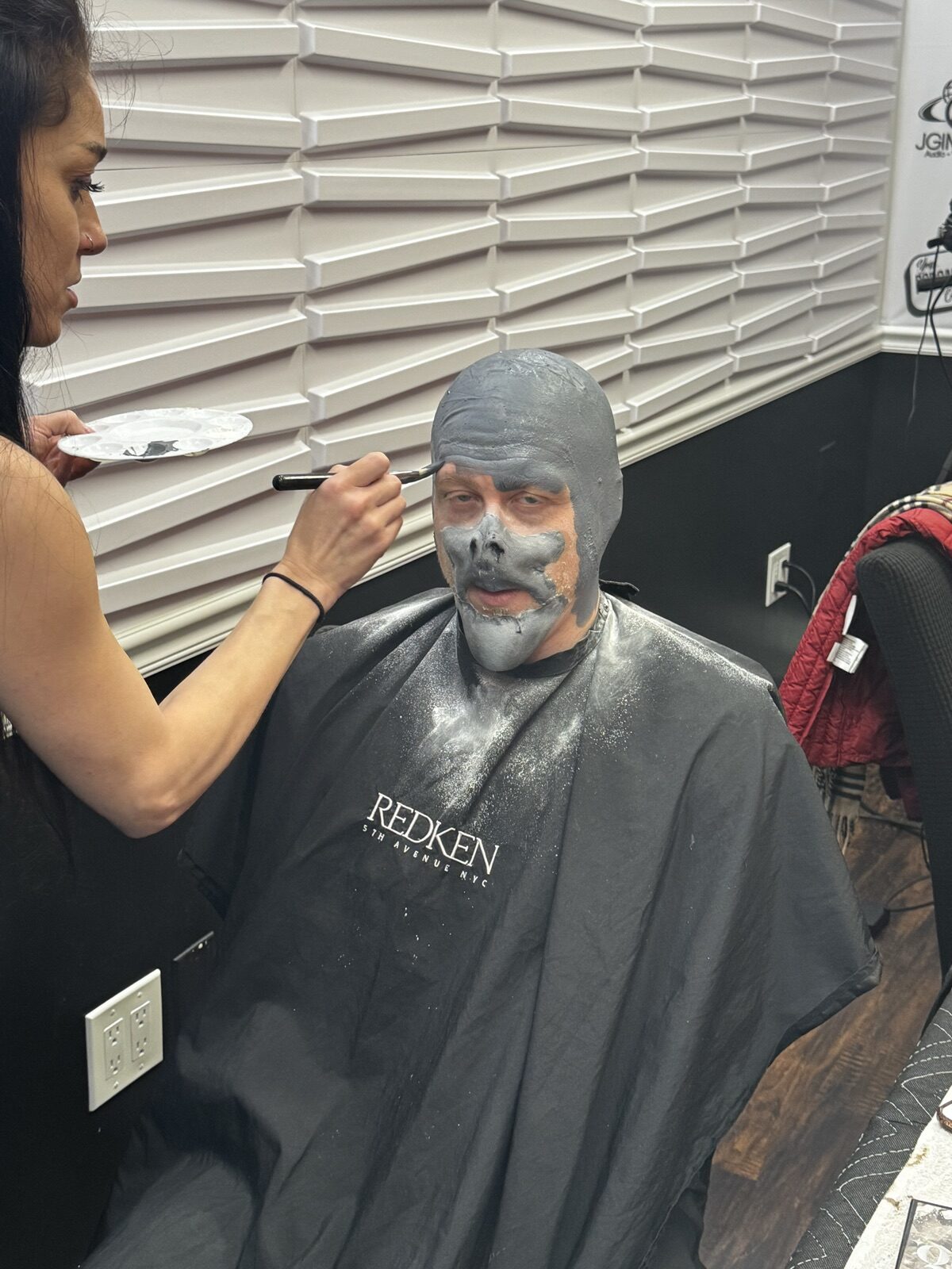 Makeup artist painting a gray creature character look on an actor at JGI Media in Albany, NY